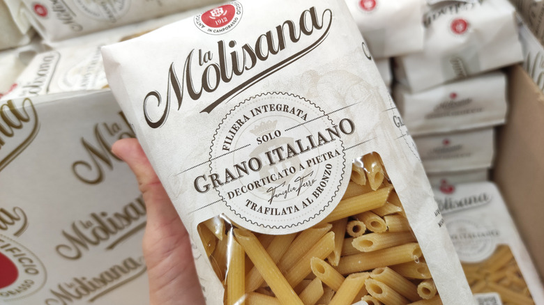 Person holding bag of pasta