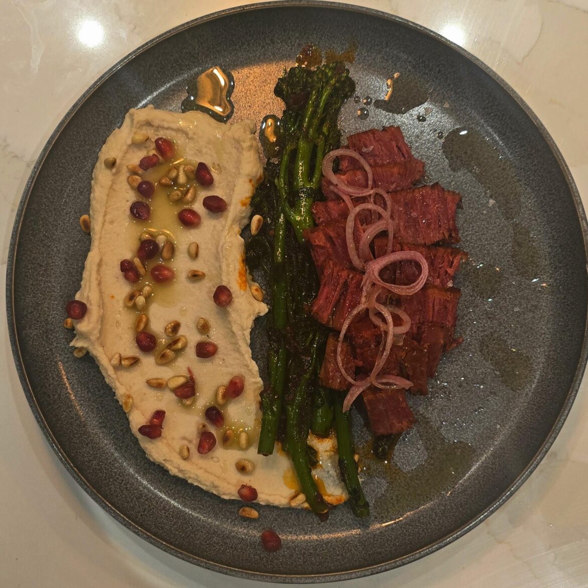 Butter bean emulsion. Pan-seared fillet vegan steak (juicy marbles). Harissa-maple charred tenderstem broccoli. Split mint-parsley oil. Sumac pickled shallots. Fond-toasted sourdough.