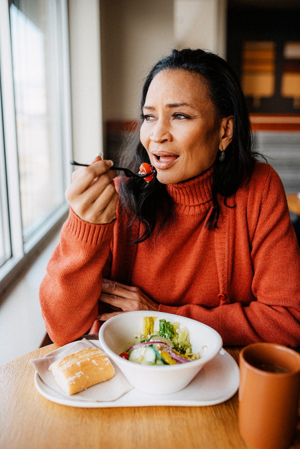 beautiful woman eating a salad at restaurant