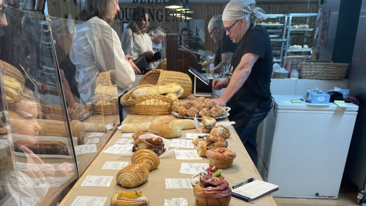 A counter is full of baked goods.