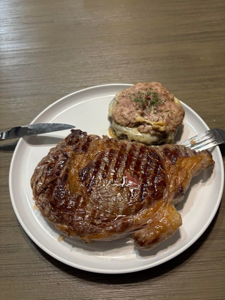Medium rare 25 OZ ribeye with pork & cheese stuffed portobello cap for dinner