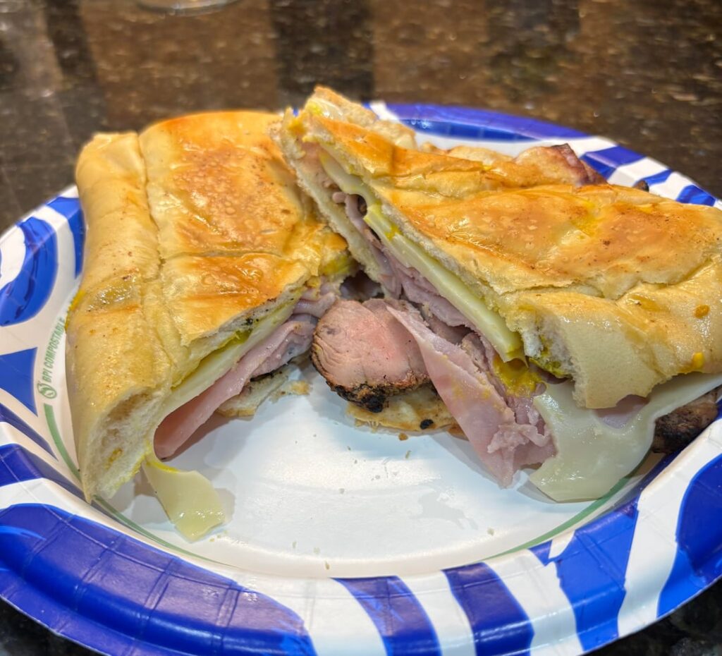 The Cuban 🤌 (smoked pork tenderloin, tavern ham, baby Swiss, pickles, mustard in buttered Cuban bread)