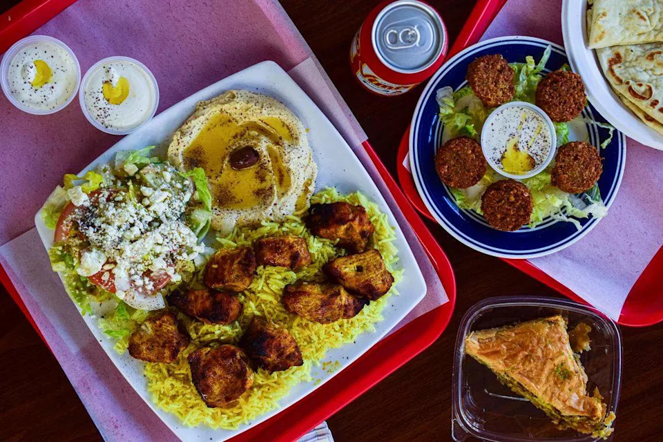 Gyro Real Kabob is a new fast-casual Greek and Middle Eastern restaurant at 11814 Pacific Ave. S. in Tacoma, Wash. On left: chicken kabob with rice, salad and housemade hummus. On right: falafel with tahini sauce and pita.