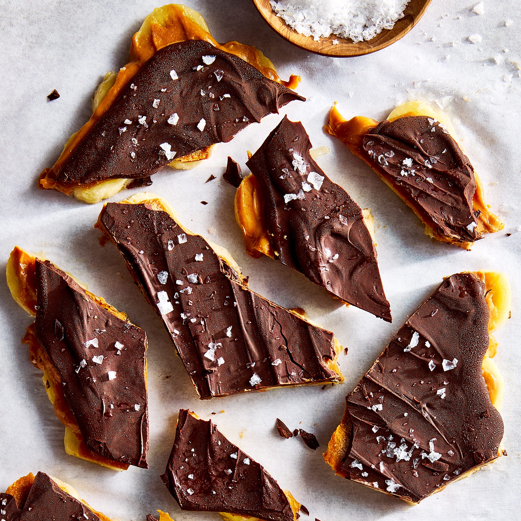 a layer of bananas gets covered in smooth, unsweetened peanut butter, then drizzled with melted chocolate and frozen until stiff enough to snap into single servings