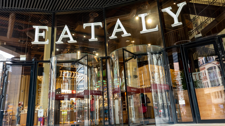 front entrance to an Eataly restaurant in London, England, with towering revolving doors and glass walls