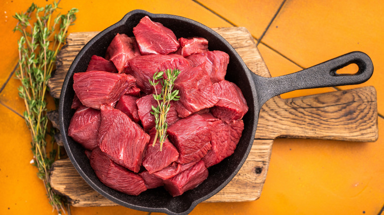 Diced elk meat in a cast iron pan