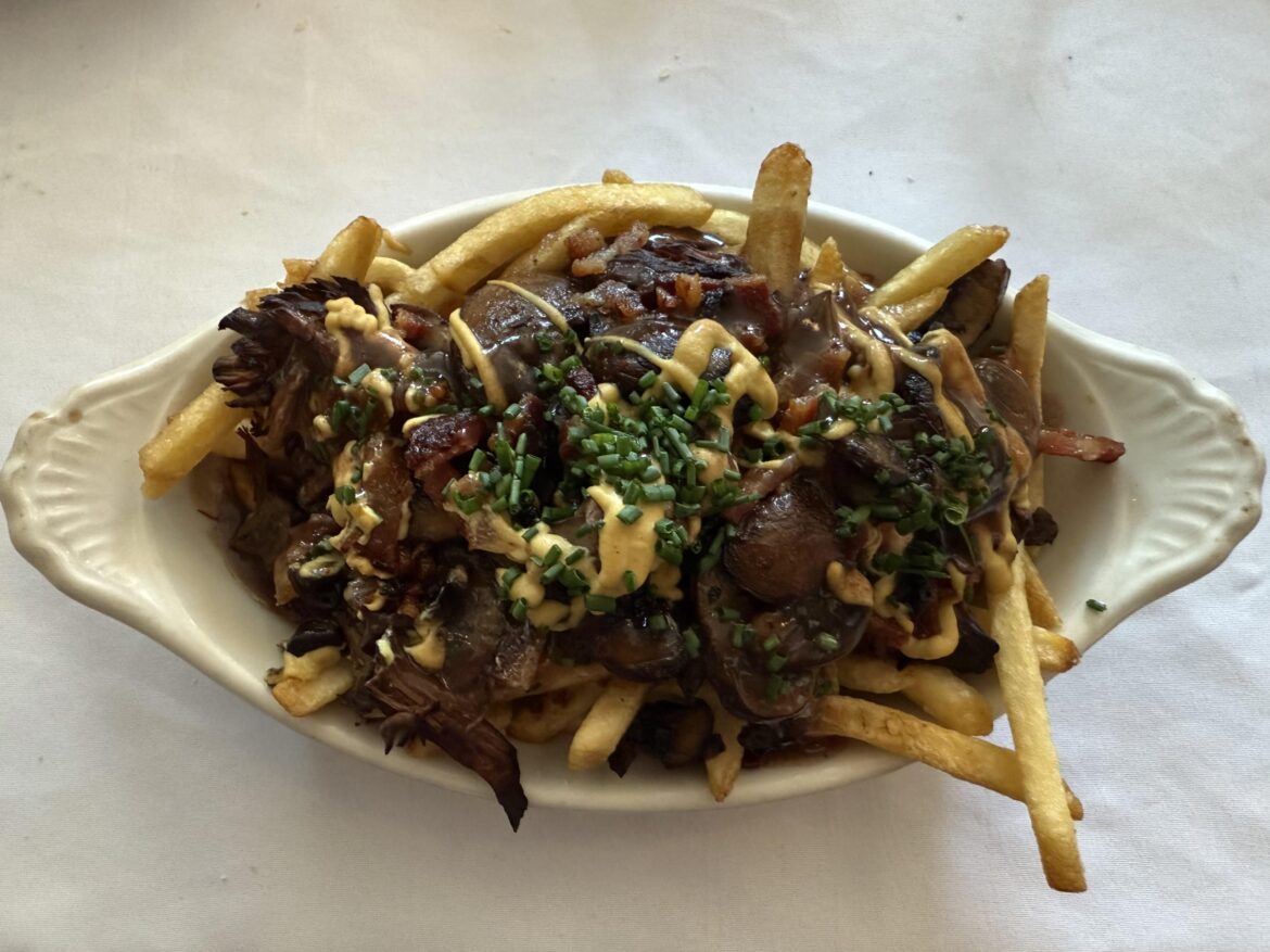 Sliced short ribs and bacon over a bed of crispy frites for brunch - Épernay Bistro | Los Gatos