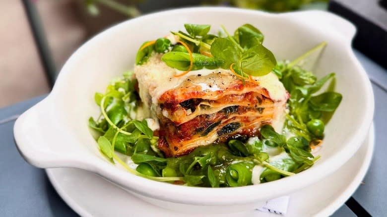 A bowl of lasagna with greens at Monteverde Restaurant & Pastifico in Chicago