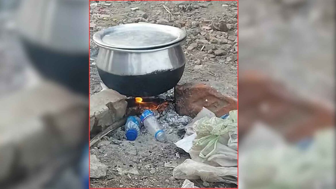 A cooking pot sits over an open fire fueled by plastic bottles and trash, showing how waste is burned for heat in poor areas.