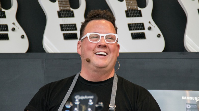 Graham Elliot wearing a microphone and smiling at an event
