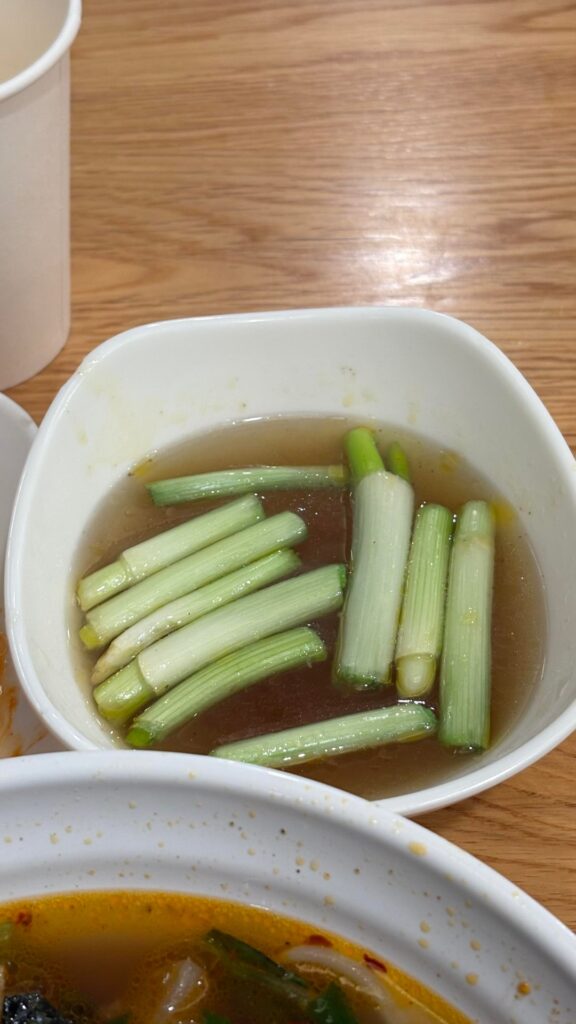 Scallion poached in fatty beef broth, served on the side of pho