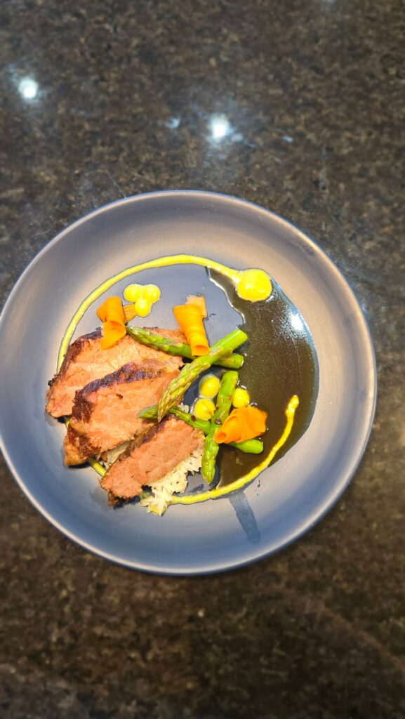 Sous vide brisket with asparagus puree, pickled carrot rolls, white rice and a soy glaze