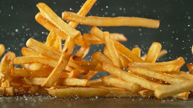 French fries tumbling onto tabletop