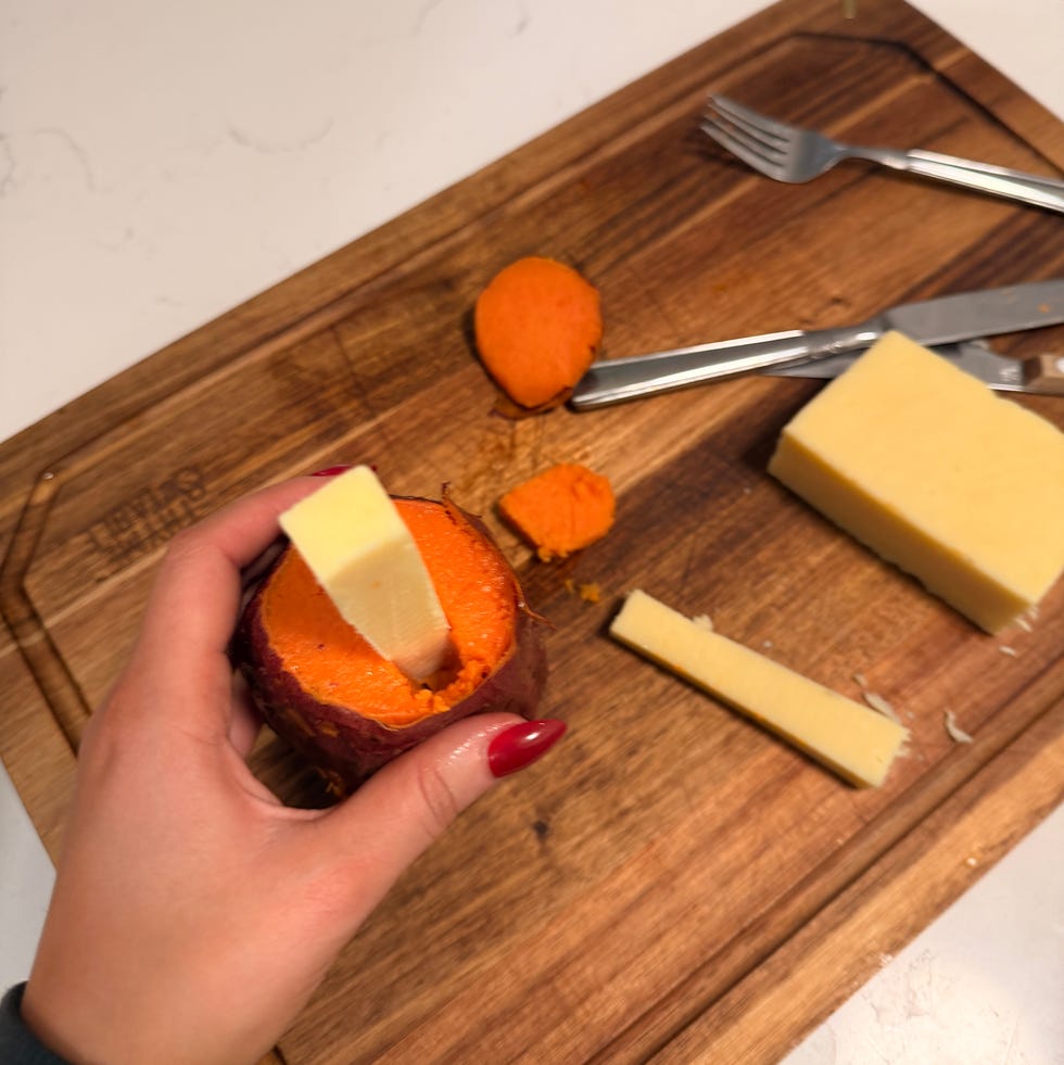 sweet potato with cheese on a cutting board