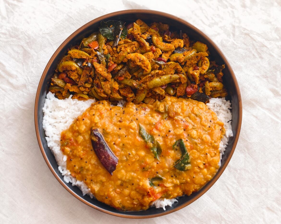 Food from otherside of world. In the frame tomato lentils stew with white rice and Ivy guard fry.