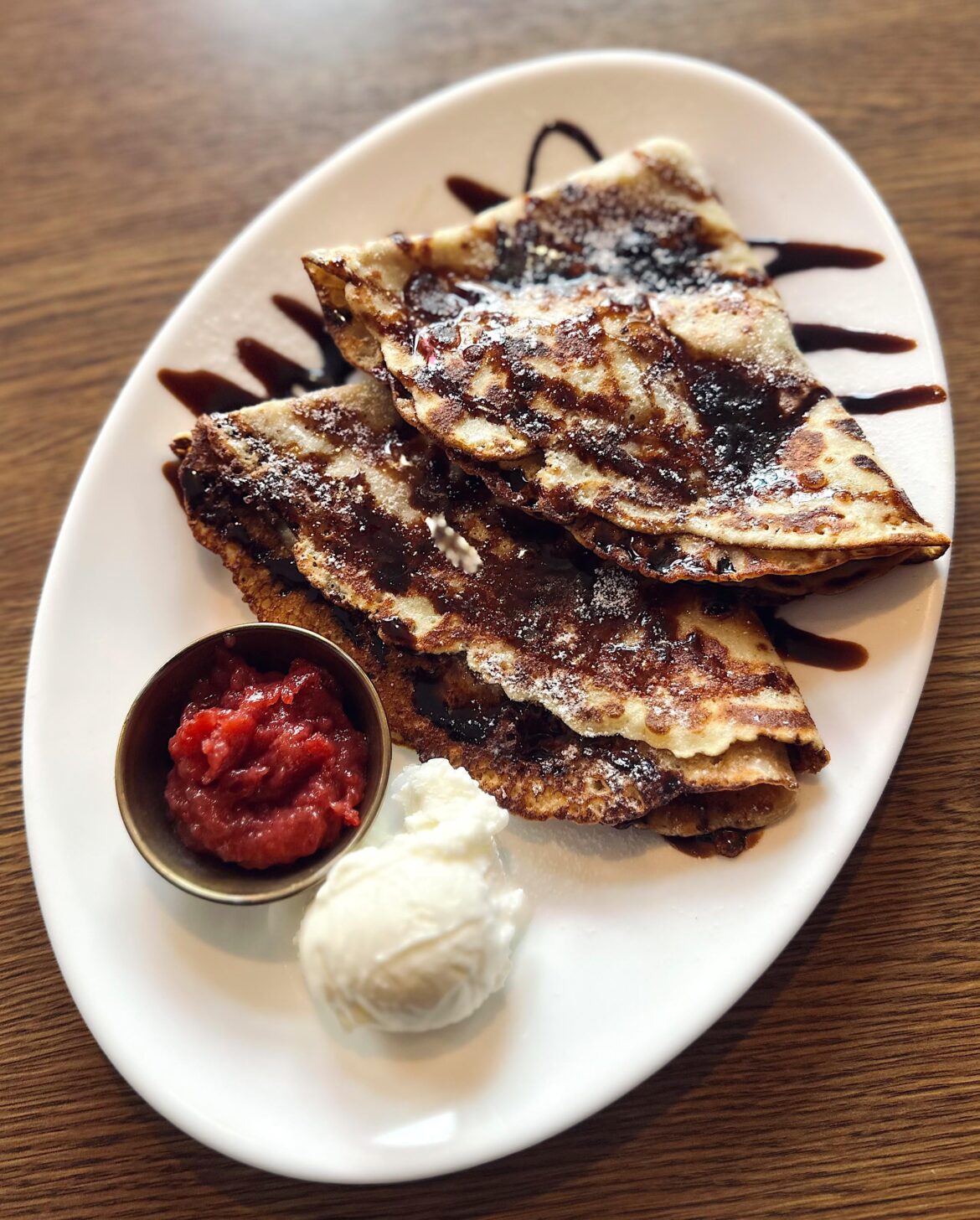Crepes, ice cream, jam and chocolate sauce