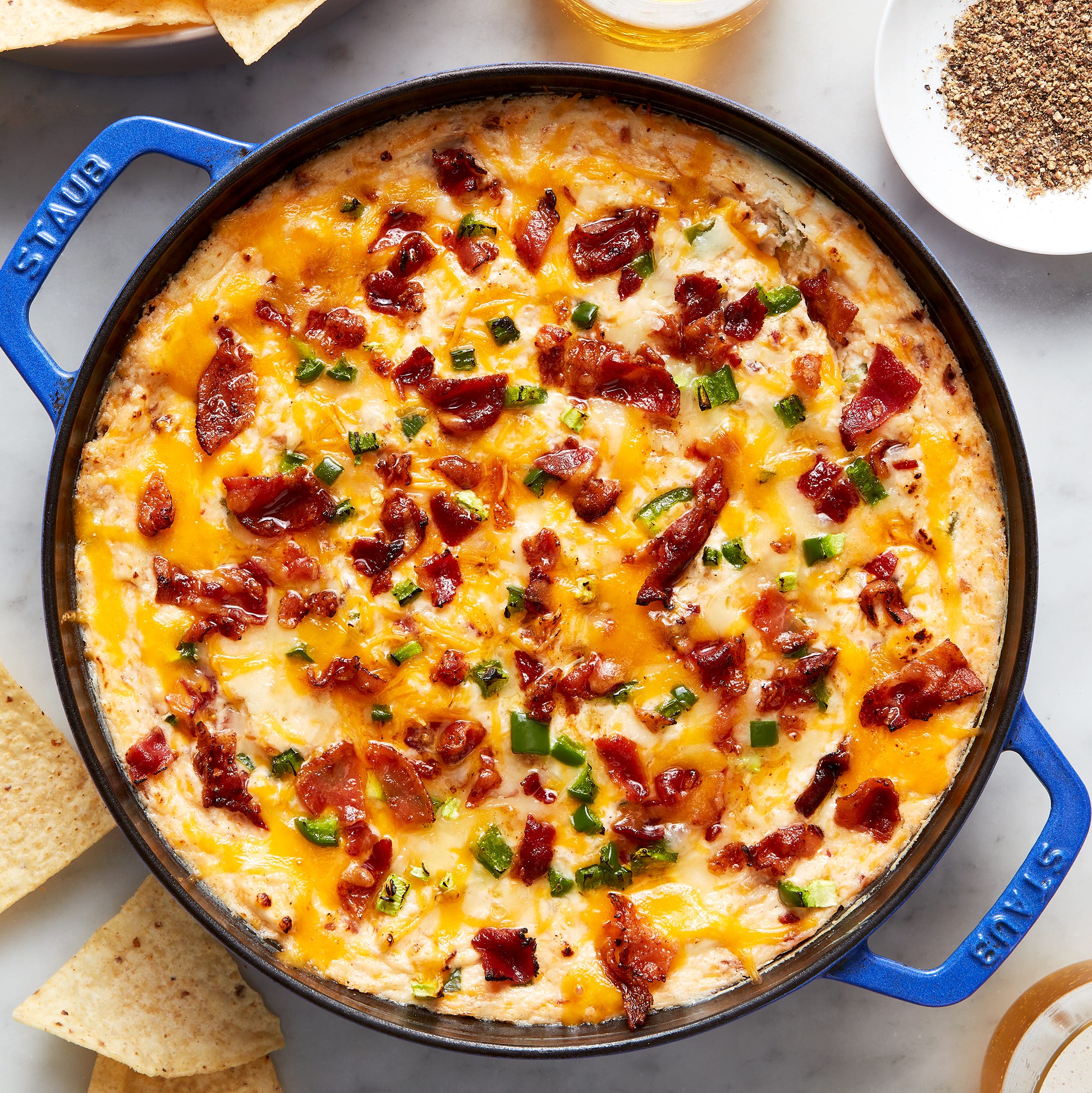 creamy cheese dip topped with bacon and diced jalapeno