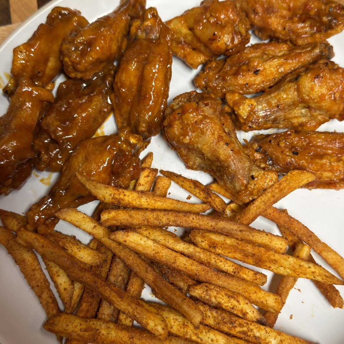 Calabrian Chili and Bar Bills Medium wings with fries tossed in BDubs Chipotle BBQ seasoning