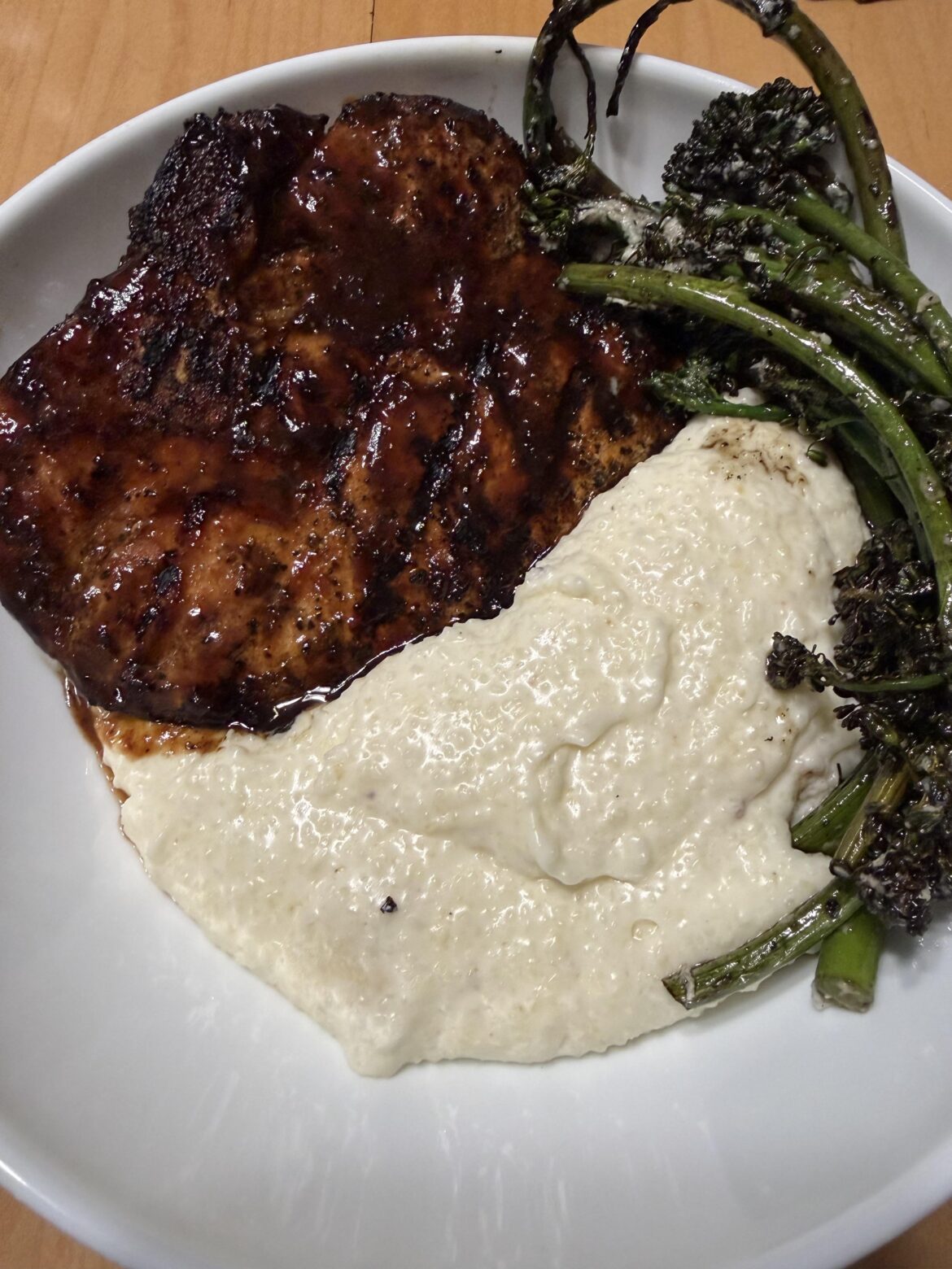 Grilled pork chop, pepper jack cheese grits and grilled broccolini