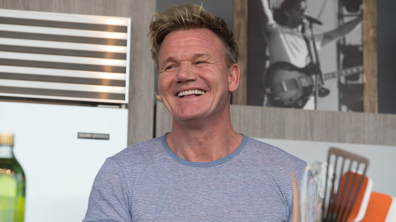 Gordon Ramsay in blue shirt smiling