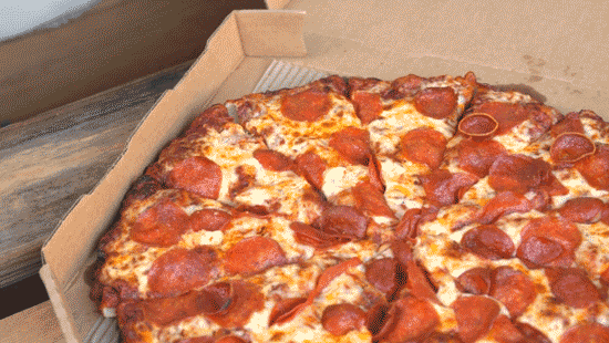 GIF of hand grabbing pepperoni pizza