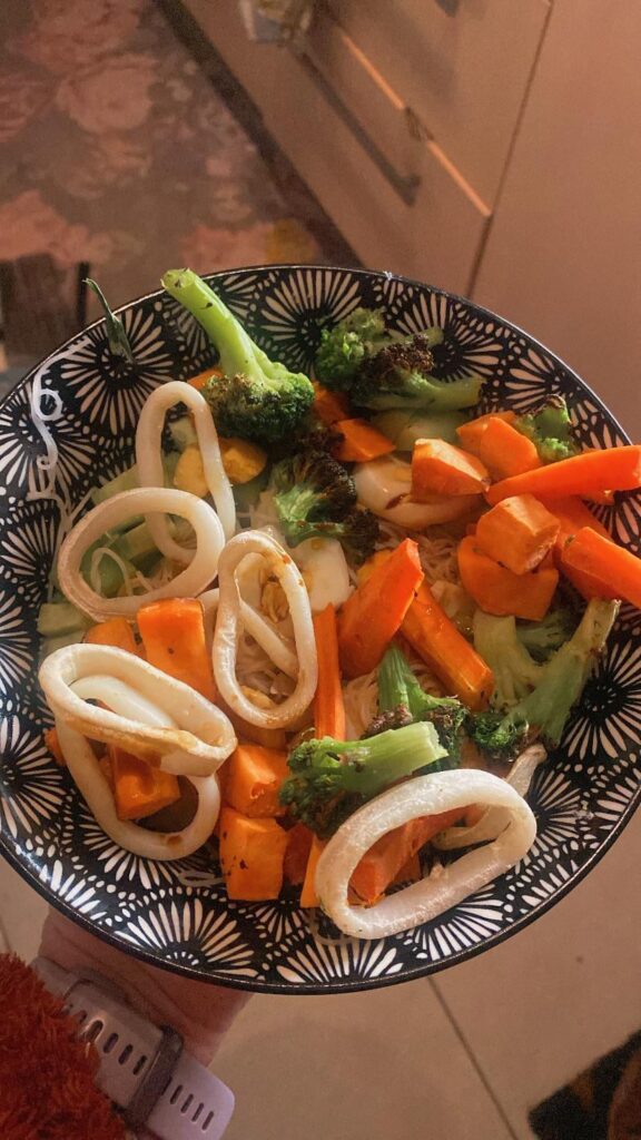 Rice noodles with squid rings, eggs, broccoli, sweet potato, carrots and cucumber