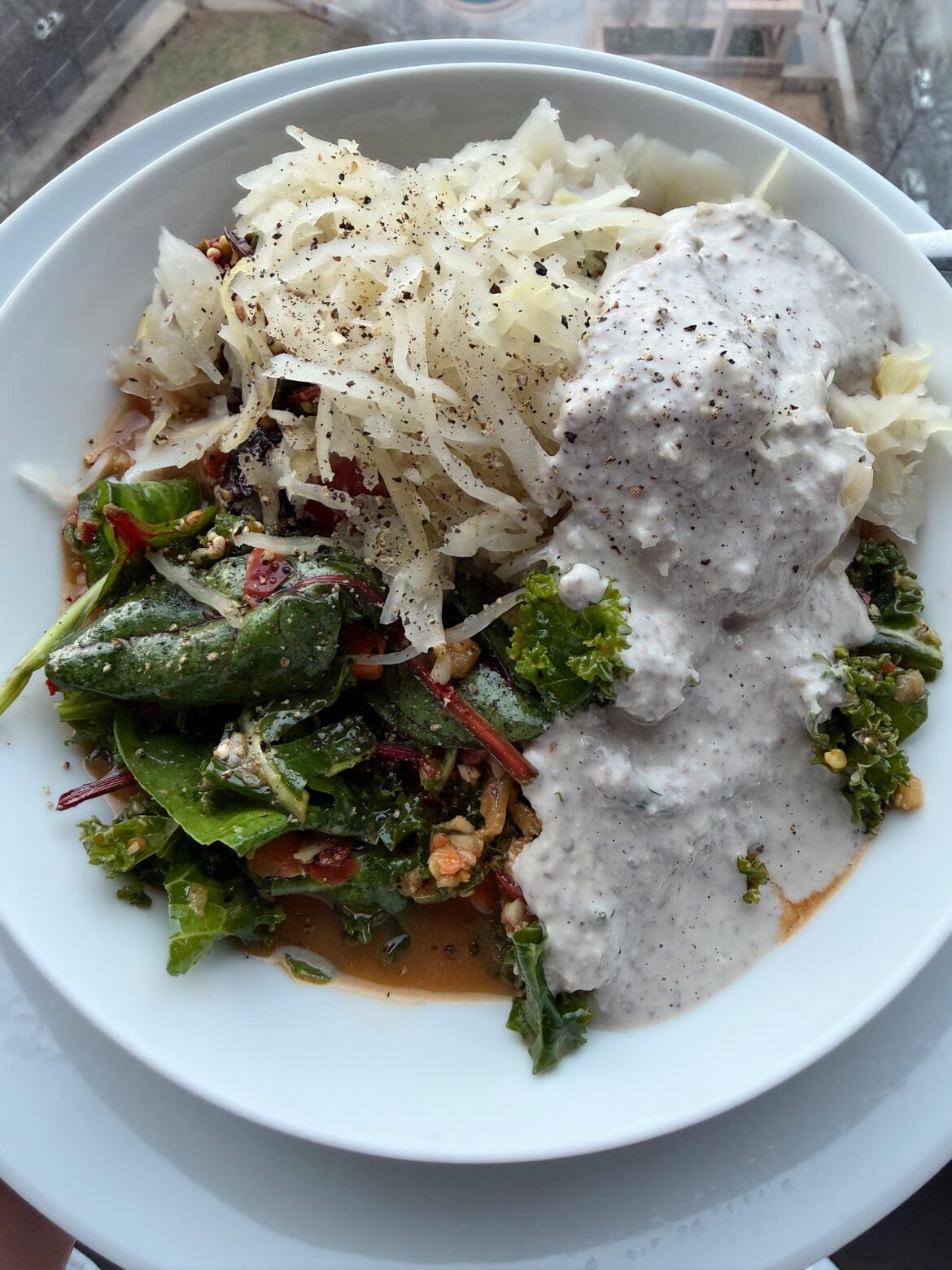 Hearty greens with Sauerkraut and homemade walnut tahini dressing