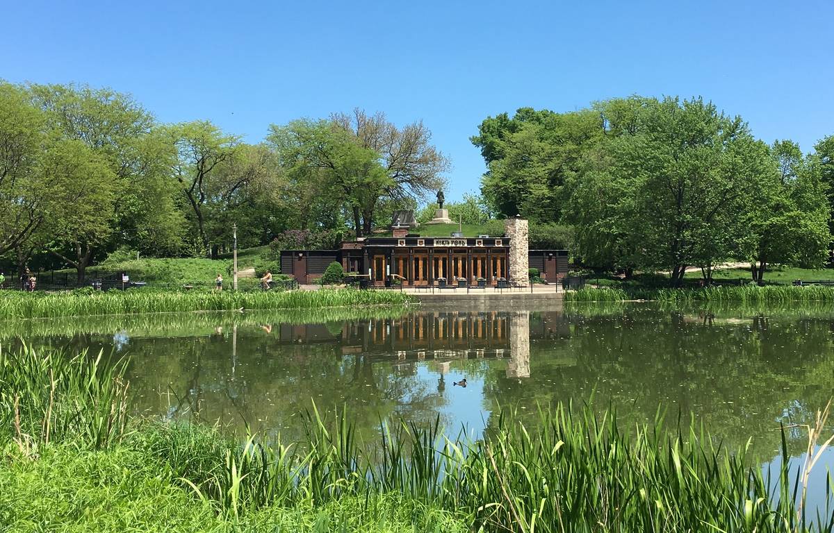 the exterior of north pond surrounded by greenery and the lincoln park pond, one of the most romantic restaurants in Chicago