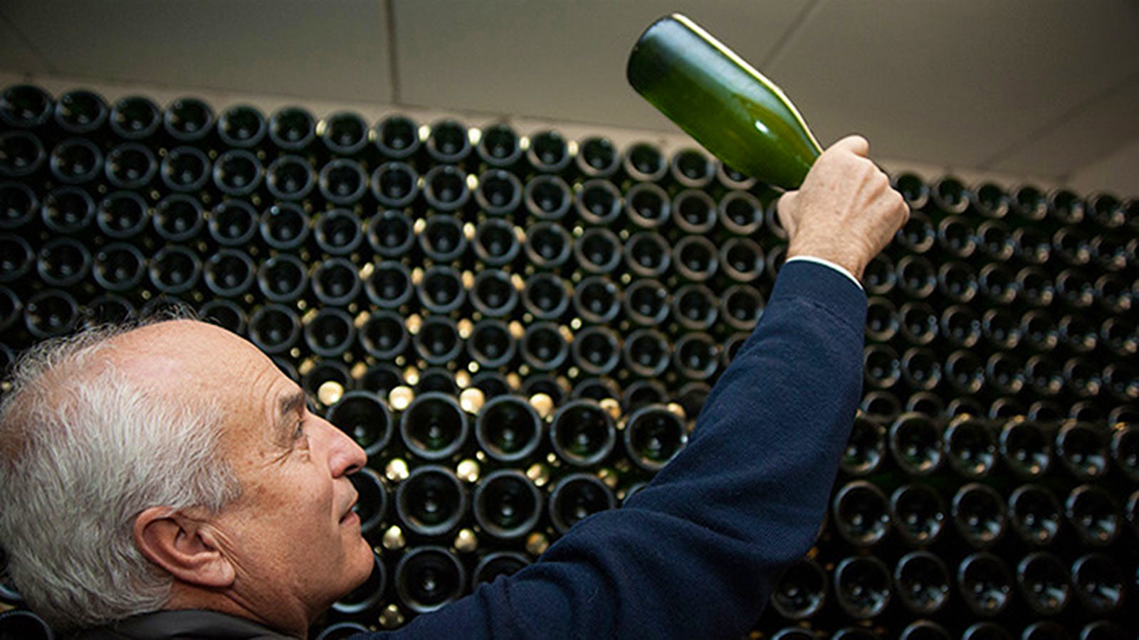  Paolo Malfer holds up a bottle of Trento sparkling wine.] 