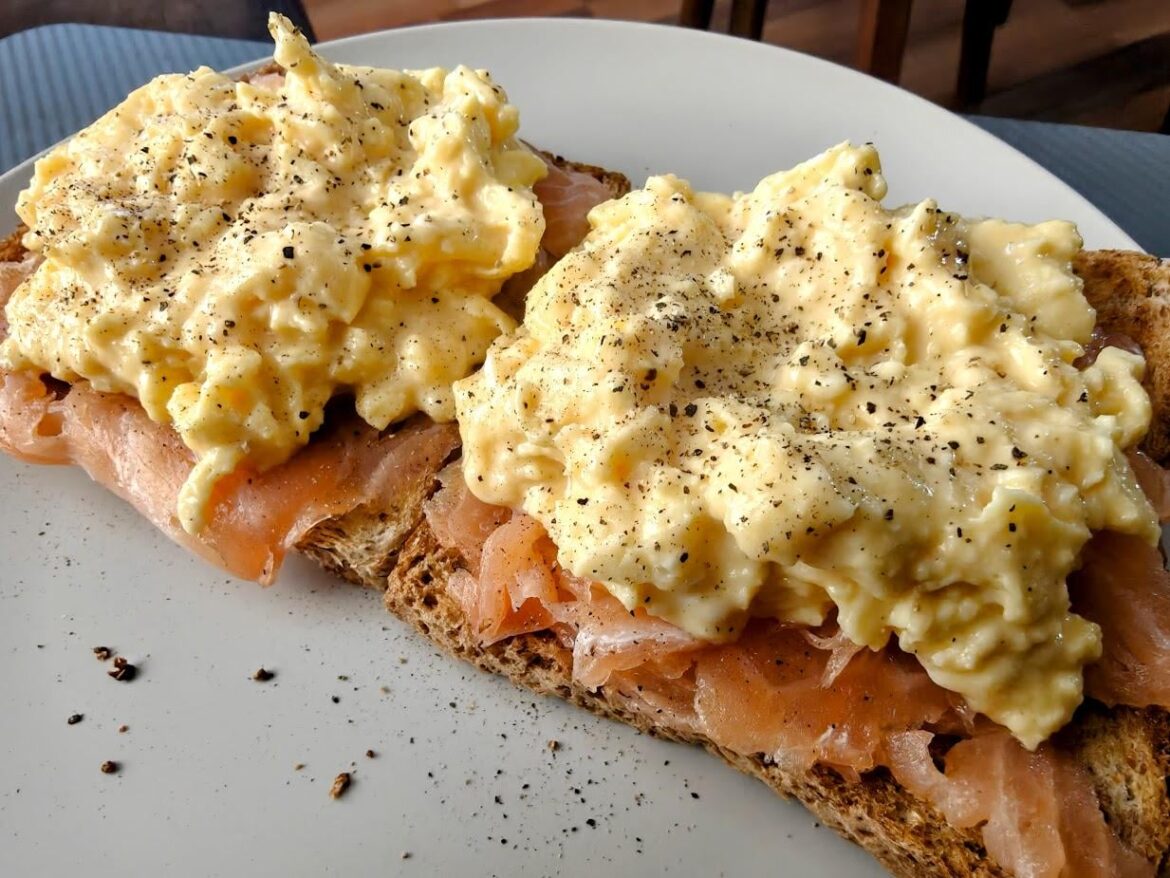 Salmon and eggs on buttery toast, lots of black pepper