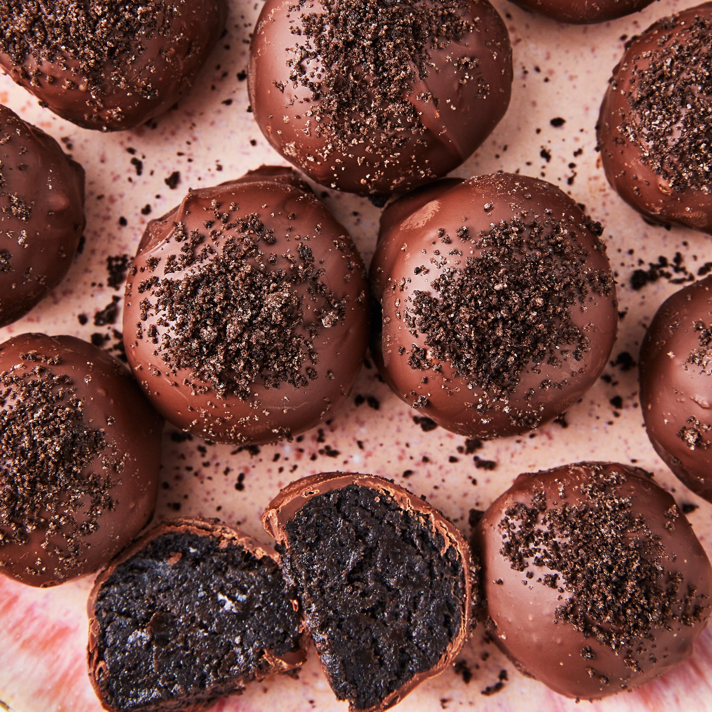 oreo cookie truffles covered in milk chocolate and topped with oreo cookie crumbs