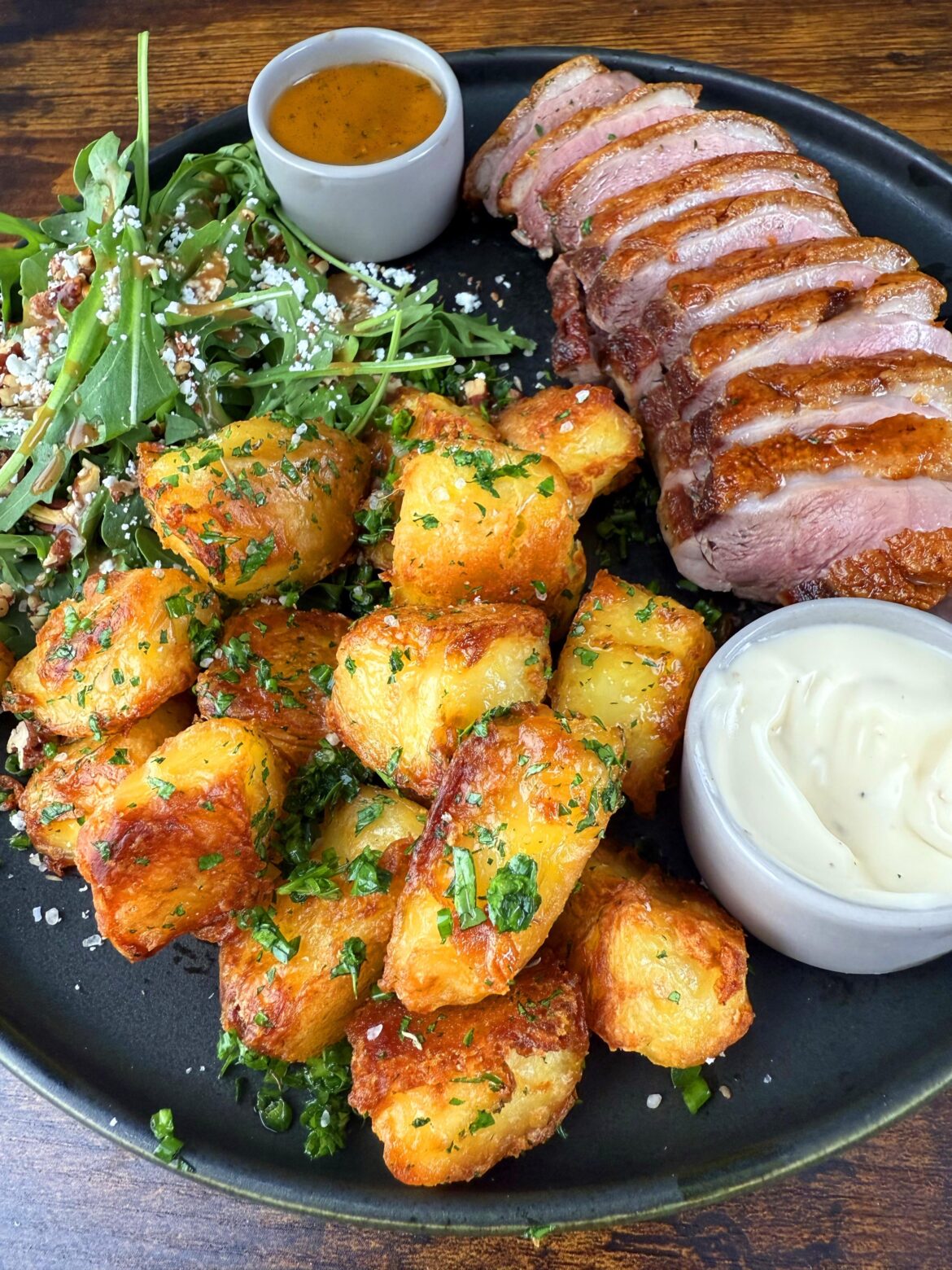 Pan-seared duck breast, crispy oven-roasted potatoes, truffle aioli, and an arugula salad