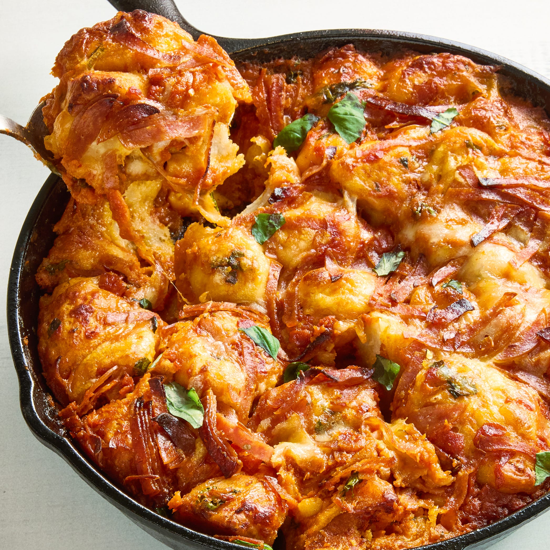 biscuits with cheese, pepperoni, and marinara in a skillet