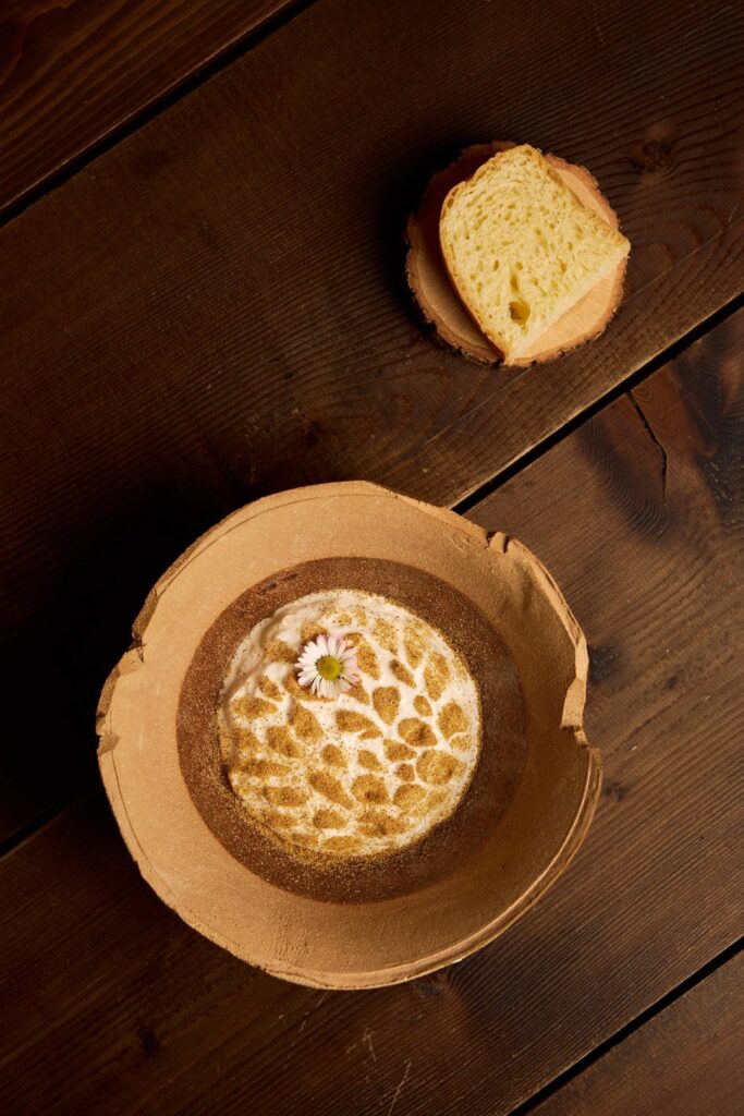 Pan brioche with Tuscan honey, Tuscan barley malt, calendula flowers, goat cheese ice cream, pollen garum