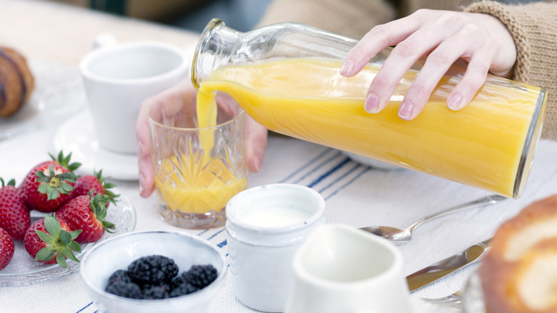 Pouring glass of orange juice