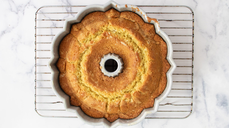 Bundt cake in pan on wire rack
