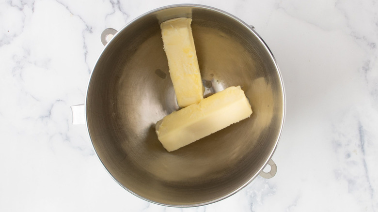 Two sticks of butter in mixing bowl