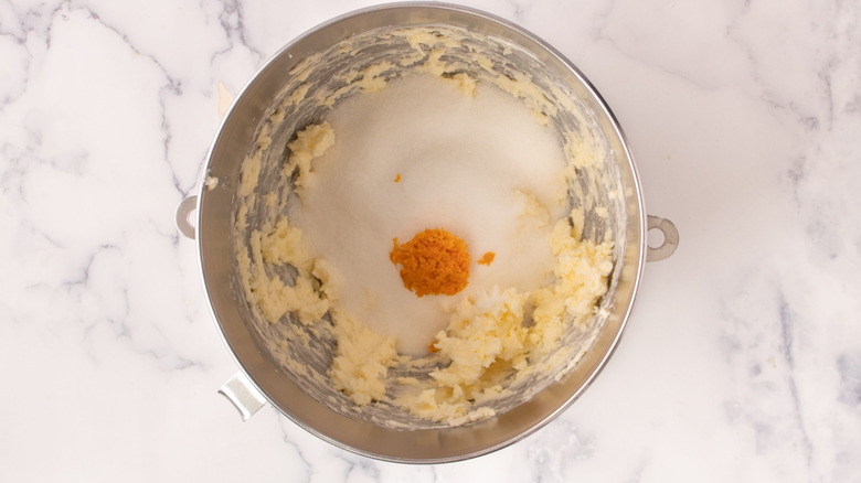 Sugar, butter, and orange zest in mixing bowl