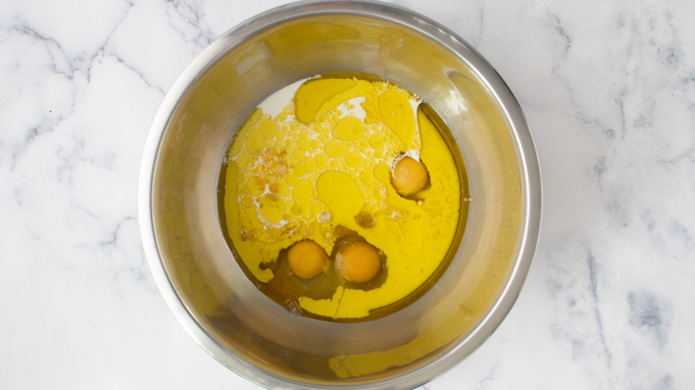 Eggs, oil, milk, and juice in mixing bowl