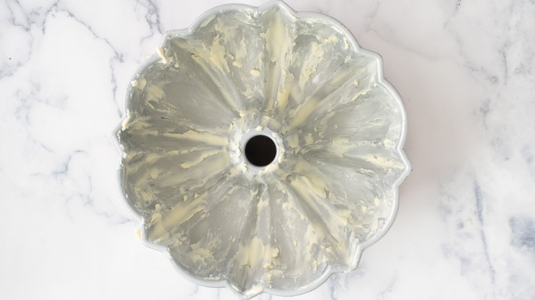 Bundt cake pan coated in butter