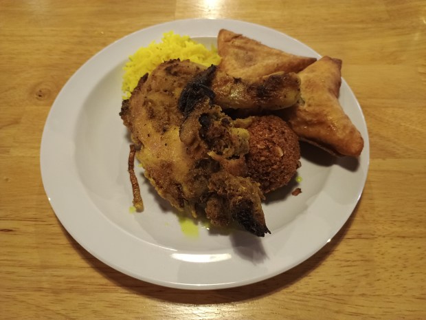 Grilled chicken, saffron rice, a falafel patty and samosas make up this buffet plate at Sawa Restaurant and Buffet in Denver, Colorado, on Feb. 1, 2026. Open Friday through Sunday Sawa offers a buffet and a menu featuring Sudanese, Mediterranean and Middle Eastern food. (Tamara Dunn, The Denver Post)