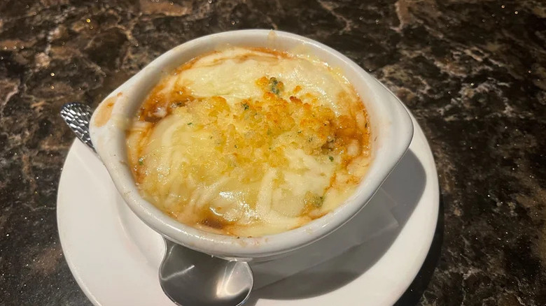 French onion soup served in a white bowl from Longhorn Steakhouse