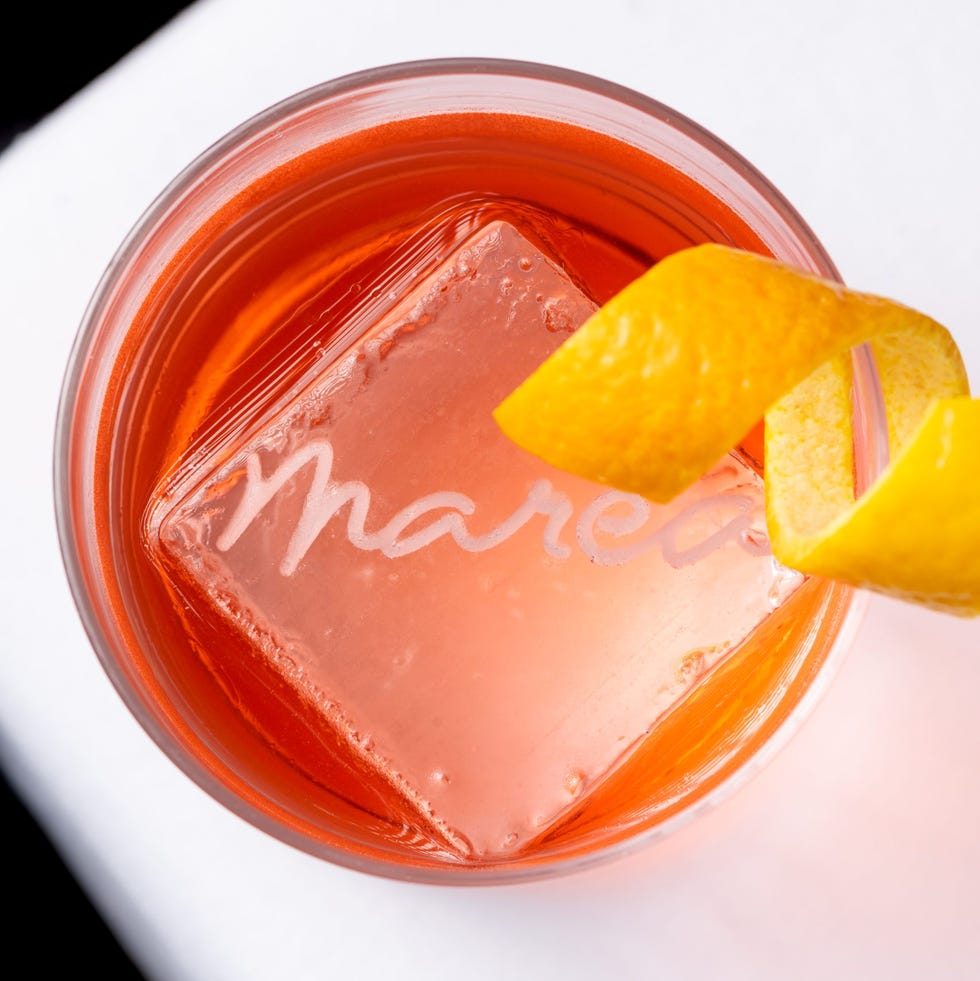 cocktail with a large ice cube and lemon twist