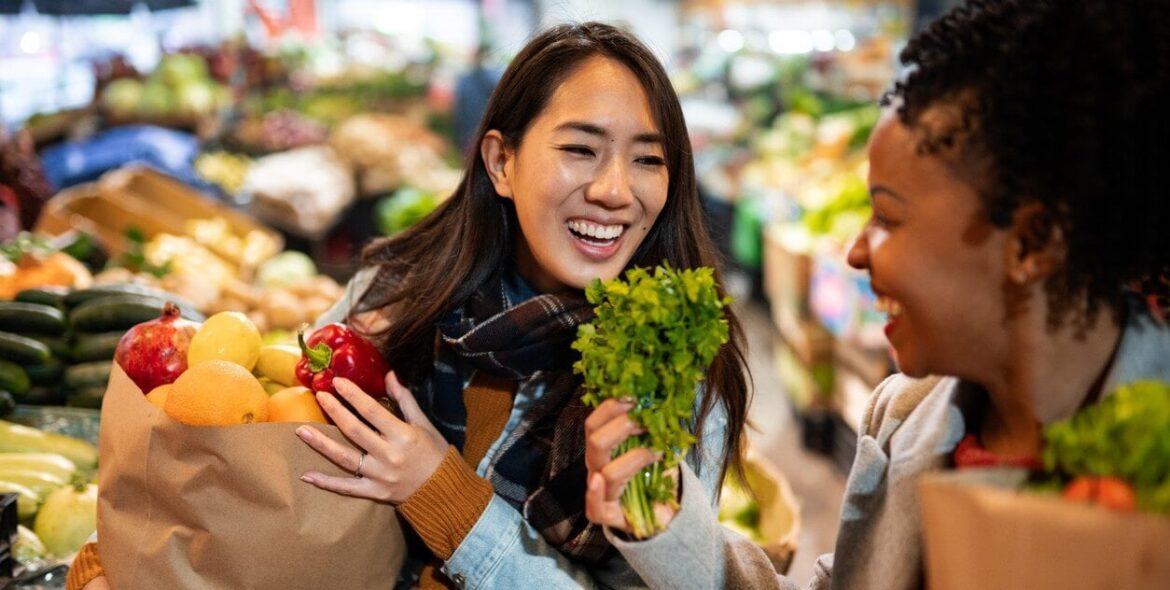 Two women buying fruit and vegetables