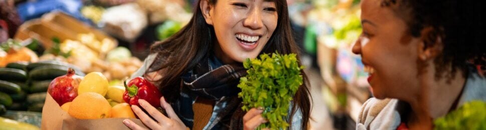 Two women buying fruit and vegetables