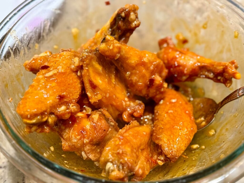 Oven baked and very crispy. The sauce is Frank’s, honey, butter, garlic, and crushed red pepper.