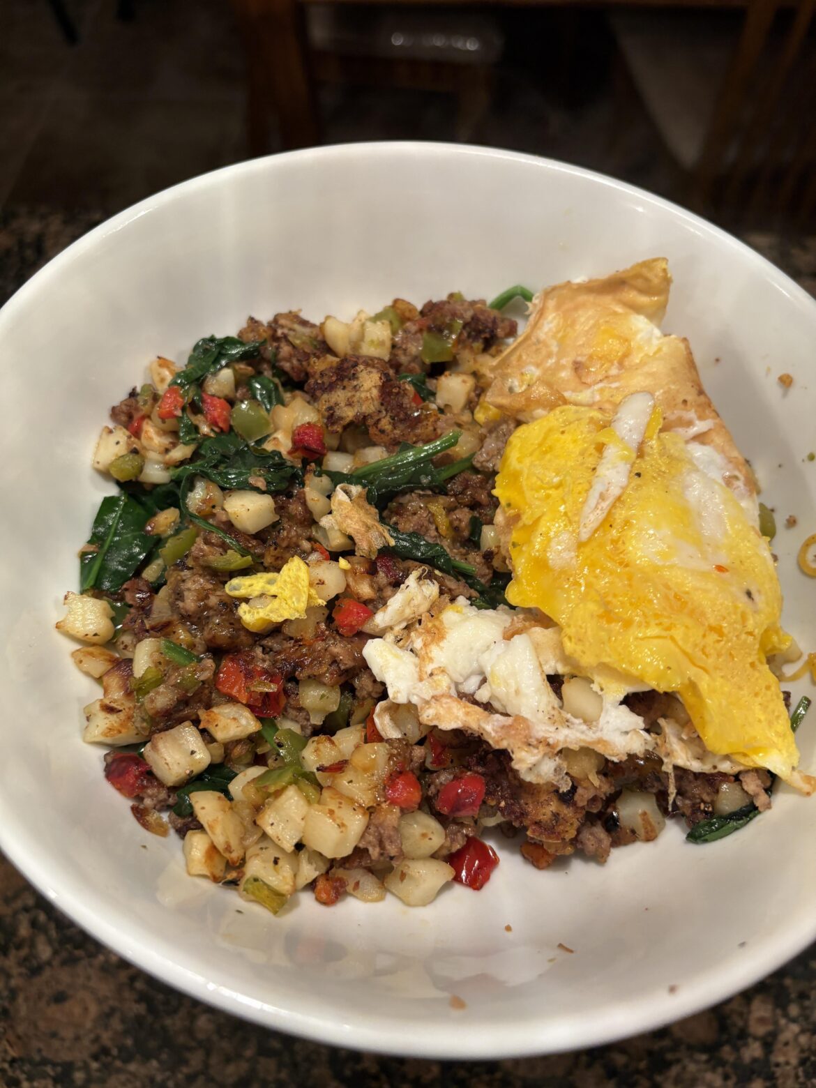 Beef and potato slop bowl with egg on top