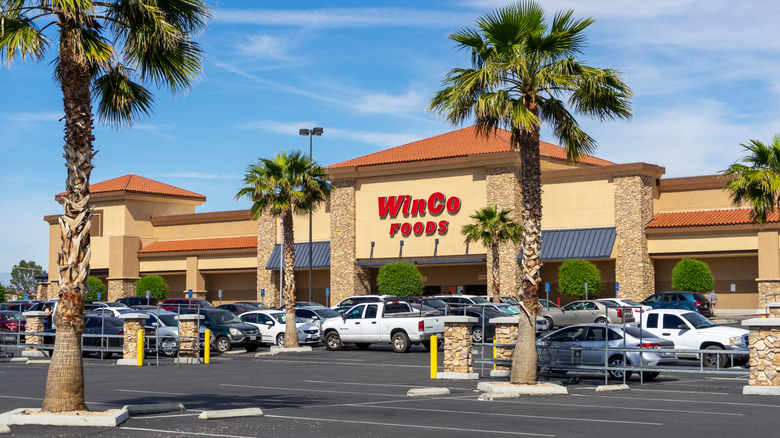 exterior of a WinCo foods with palm trees in the parking lot