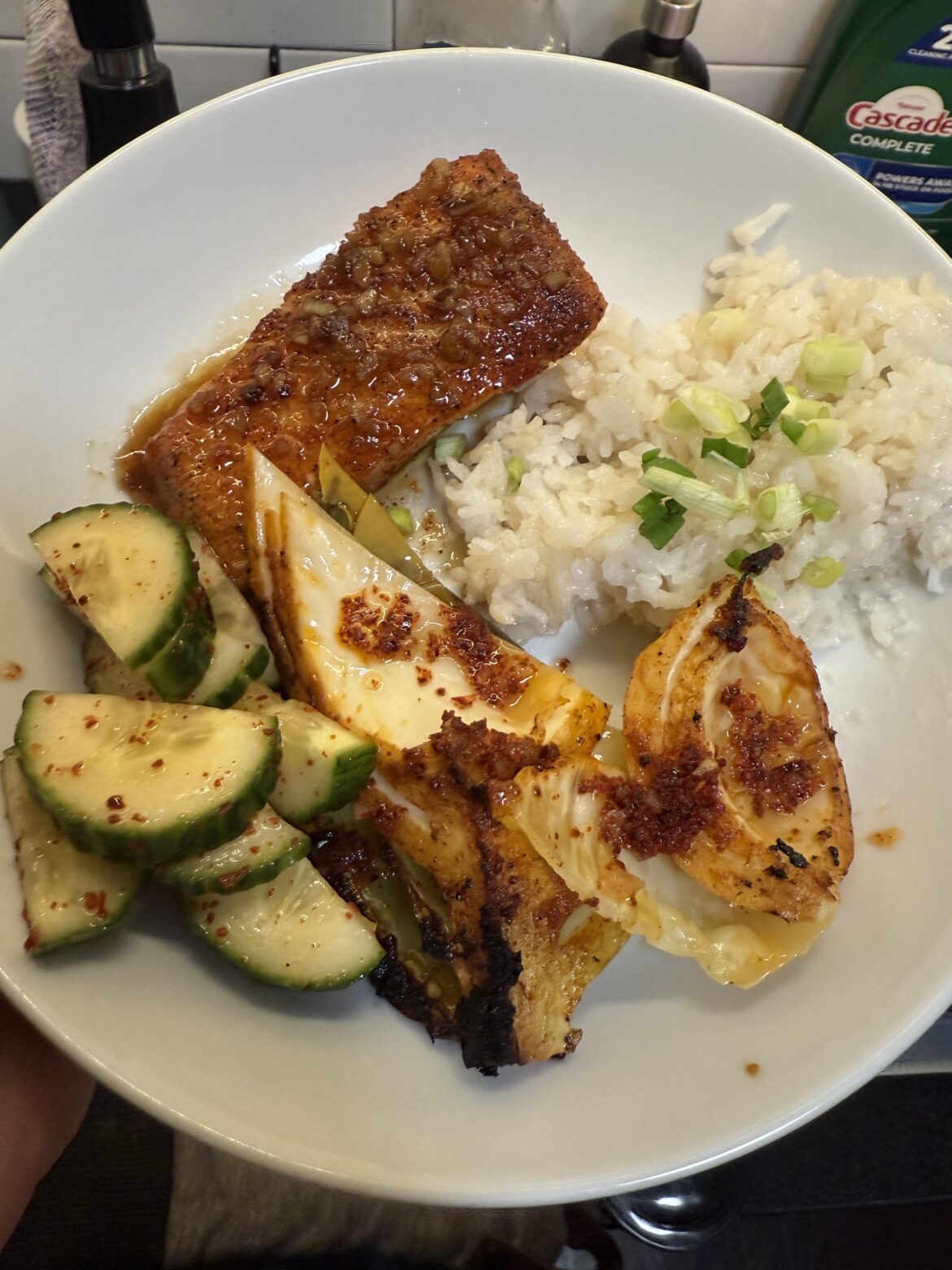 Brown sugar garlic salmon, miso butter gochujang roast cabbage, seasoned cucumbers and rice