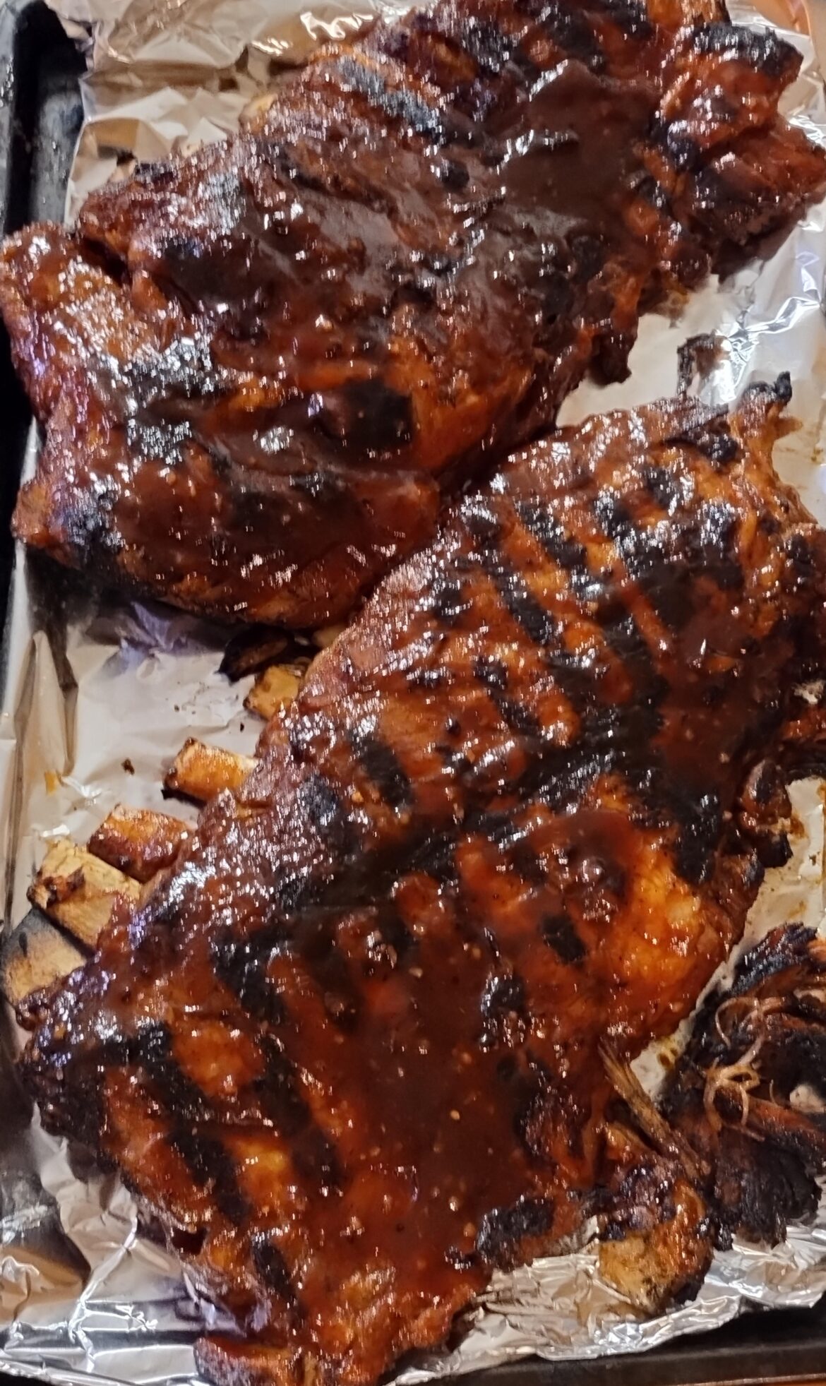 36 hour dry rub, four hours oak/cherry smoked @ 220° (no bark), 20 minutes on the grill w/ sauce. Fall off the bone. Potato quality phone.